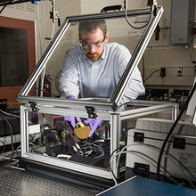 NIST researcher Chris Stafford is using a modified commercial instrument to measure the characteristics of different chemical formulations of ultra-thin sheets of plastic