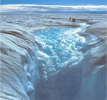 A glacial-melt stream on the top of the Greenland ice sheet in late summer. The stream is falling into a moulin where it travels to the base of the ice sheet.