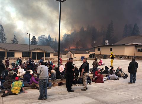 Picture of people taking refuge in the parking lot of Optimo Restaurant in Paradise, CA, on November 18, 2018