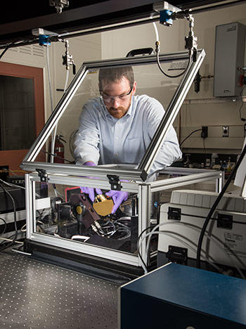 NIST researcher Chris Stafford is using a modified commercial instrument to measure the characteristics of different chemical formulations of ultra-thin sheets of plastic