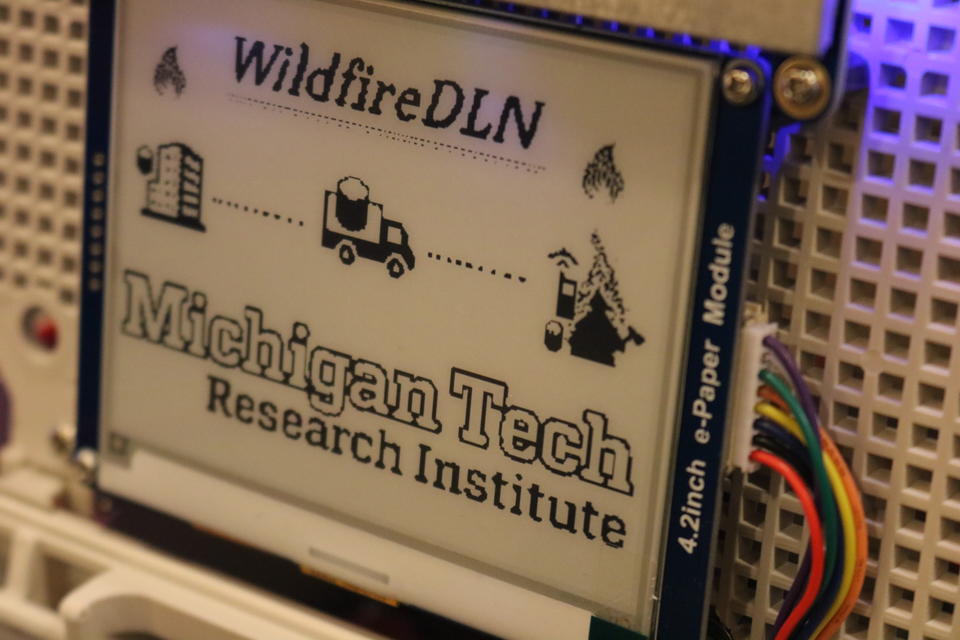 Shows the Michigan Tech data ferry, printed text reads "Wildfire DLN Michigan Tech Research Institute"