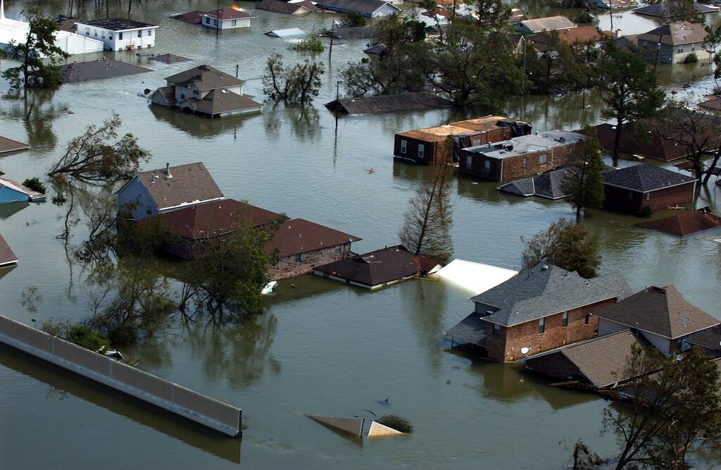 Aerial of a flooded neighborhood with streets and homes totally submerged.