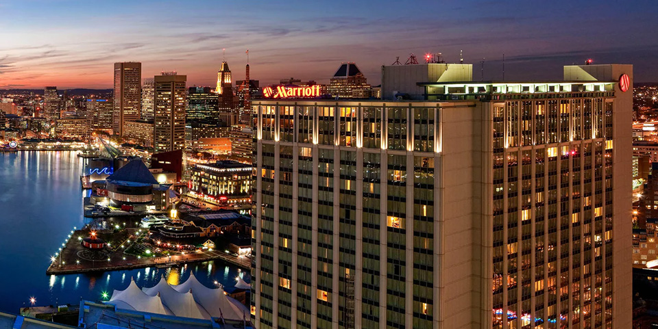 Baltimore Marriott Waterfront night photo showing hotel and the harbor.