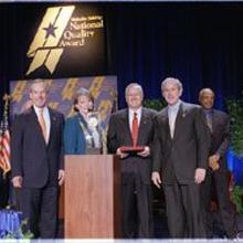 (Left to right) Commerce Secretary Don Evans; Karen Hollingsworth, vice president, First in Service Performance Excellence, Clarke American Checks; Charles Korbell, president and CEO, Clarke American Checks; President Bush; Education Secretary Rod Paige.