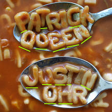 Two spoons hover above a bowl of alphabet soup. The letters on one spoon spell the name PATRICK QUEEN. The letters on the other spoon spell the name JUSTIN OHR. Green lines appear under the letters needed to spell the name JOHN 