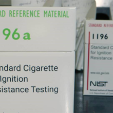 A box of cigarettes is labeled: Standard Cigarette for Ignition Resistance Testing.