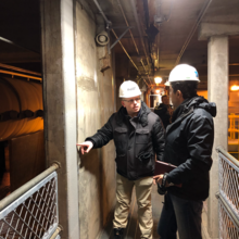 David Goodwin (left)  and Siamak Sattar from NIST’s Materials and Structural Systems Division examining a wall at the Anchorage Water and Wastewater Treatment Plant after an earthquake in Alaska 2019.