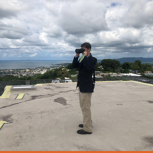 NIST research structural engineer Joe Main on the roof of the Hospital Bella Vista in Mayaguez, Puerto Rico in 2017. Joe is photographing the surrounding terrain to document local topography and surface roughness.