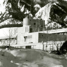 building in the foreground; mountains in background
