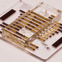A transparent chip has metallic bars crossing it. 