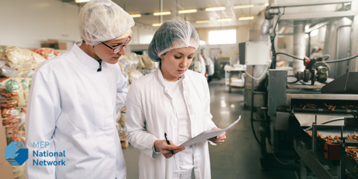two female factory workers in a food processing plant