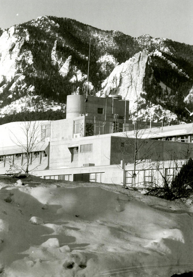 building in the foreground; mountains in background