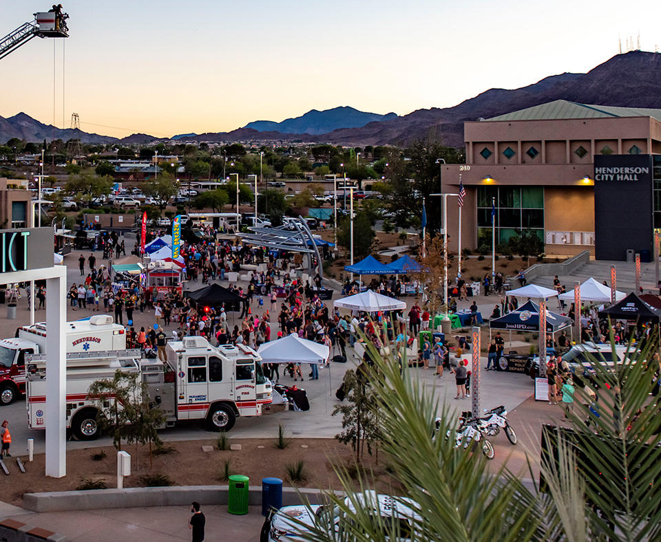 The City of Henderson National Night Out photo showing City Hall, police and rescue services, and vendors with the community enjoying the events.