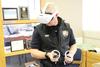 First responder wearing a virtual reality headset and holding controllers in his hands