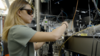 Sun Park wears safety glasses as she adjusts wiring and equipment in the lab. 