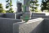 a machine 3d printing a single-family home built out of concrete