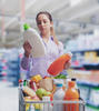 Consumer examining bottle labels in grocery store