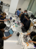 A group of students in a laboratory with computers and equipment