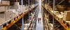 High angle view of a warehouse manager walking with foremen checking stock on racks